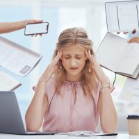 Stress, burnout and busy woman in the office with headache, tasks and projects from coworkers. Over.